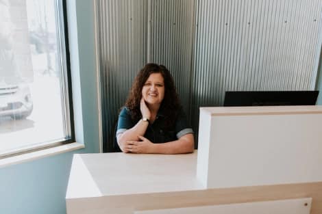 Stacy, the owner of Lotus Laser Aesthetics, at the front desk ready to welcome clients for personalized skin treatments.